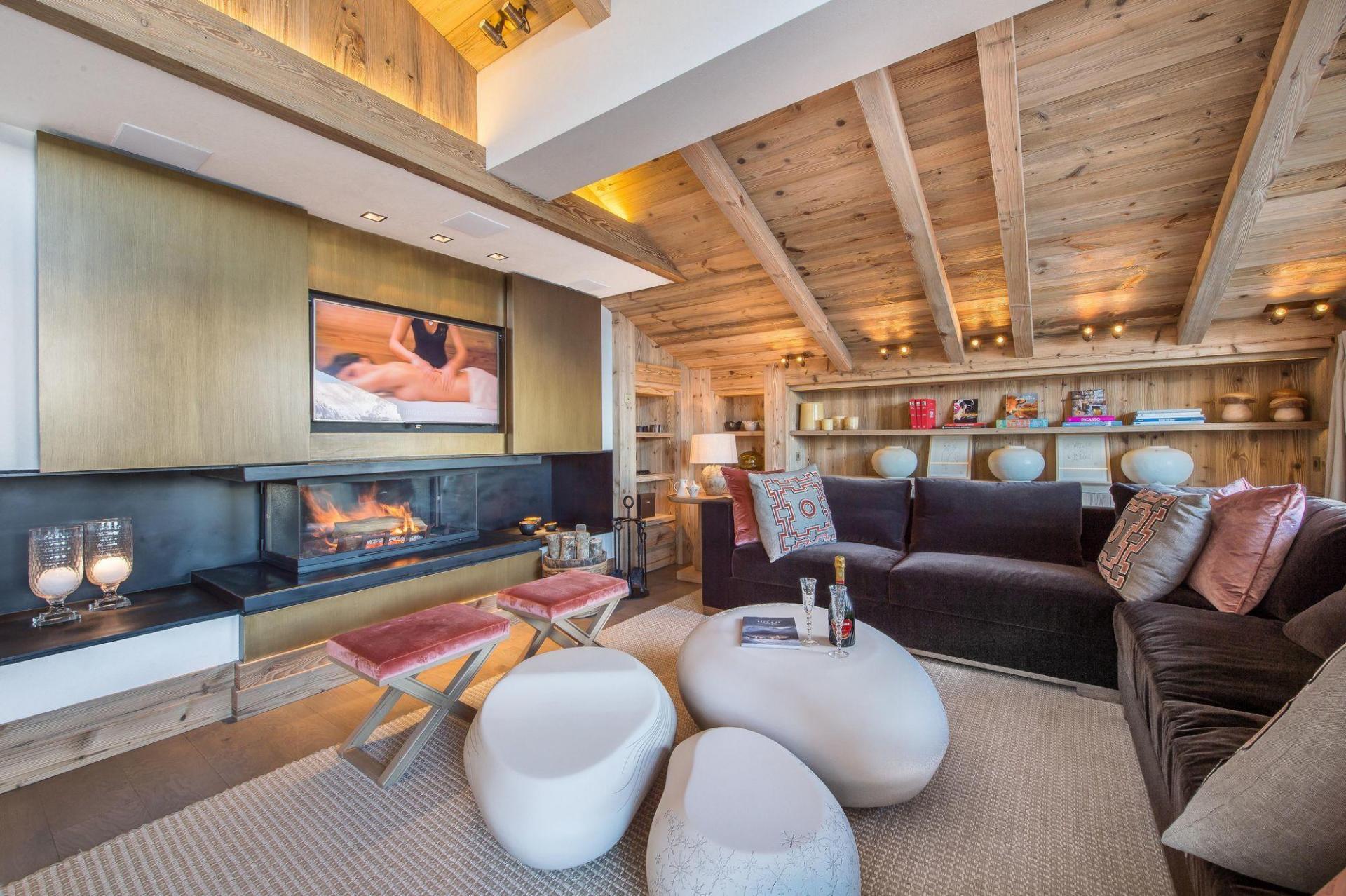 THE LOUNGE AND ITS FIREPLACE IN CHALET DES CHENUS IN THE FRENCH ALPS